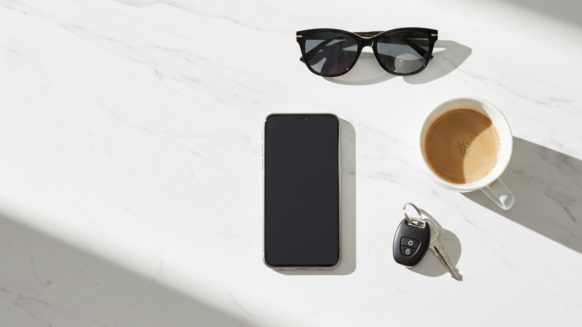 Smartphone lying face-down on a kitchen counter beside coffee and keys — a common sign a wife is hiding app activity